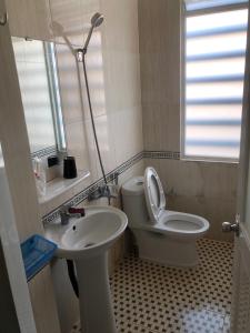 a bathroom with a toilet and a sink at Gia Han Guesthouse in Vung Tau