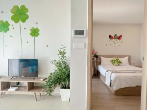 a bedroom with a bed and a desk with a television at CĂN HỘ CAO CẤP THE SONG VŨNG TÀU - LUXURY APARTMENT THE SÓNG VŨNG TÀUs in Vung Tau +93 photos