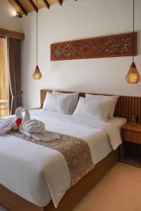 a bedroom with a bed with a stuffed animal on it at Jisa Sidemen in Sidemen