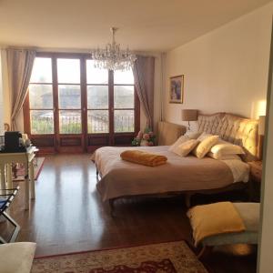 a bedroom with a large bed and a large window at Chez Jack Confolens in Confolens +63 photos