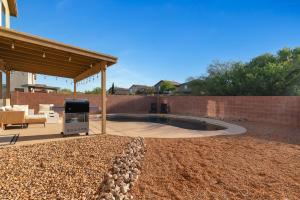 a backyard with a fire pit and a pavilion at Cactus Retreat Pool Fire Pit Pet Friendly in Green Valley
