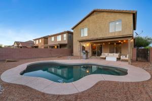 a swimming pool in front of a house at Cactus Retreat Pool Fire Pit Pet Friendly in Green Valley