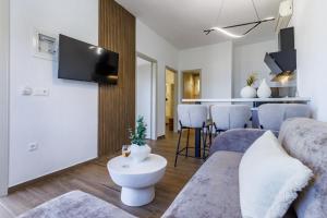 a living room with a couch and a table at Kastri Houses in Panormos Skopelos