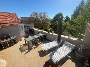 a patio with a table and chairs and an umbrella at The Hampton Hock's - Wellness & Wine in Freinsheim