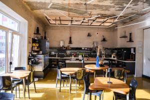 a room with tables and chairs and a kitchen at Smarthotel Nezvalova Archa in Olomouc
