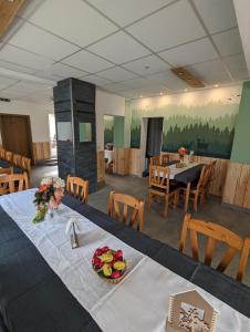 a dining room with a table with a bowl of fruit on it at Gästehaus Stein im Thüringer Wald in Rottenbach