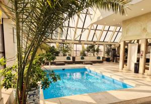 a swimming pool in a lobby with a building at Park Plaza Santiago in Santiago +40 photos