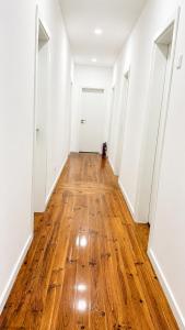 an empty hallway with wood floors and white walls at Avenidas Prime Lisbon in Lisbon