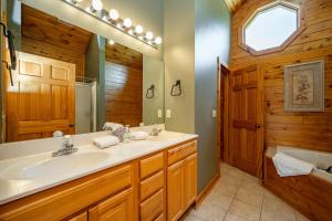 a bathroom with a sink and a tub at Cedar Shores Villa #08 by Railey Vacations in McHenry