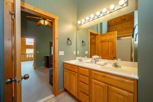 a bathroom with a sink and a mirror at Cedar Shores Villa #08 by Railey Vacations in McHenry