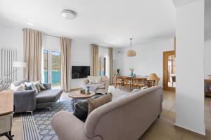 a living room with a couch and a table at Villa Helia in Yénion