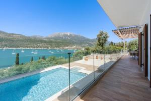 a house with a swimming pool and a view of the water at Villa Helia in Yénion