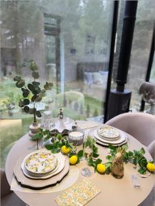 a white table with plates and lemons on it at Luxury Tahkuranna SPA villa Pärnu in Laadi