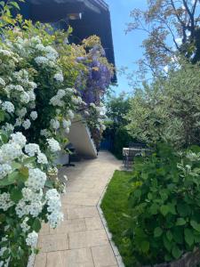 a garden with purple and white flowers and a building at Ferienwohnung Pickert in Bad Endorf