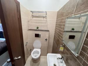a small bathroom with a toilet and a sink at MorningInn in Prayagraj