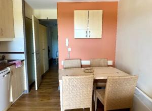 a kitchen with a table and chairs in a room at Residence Cap Esterel Babou in Saint-Raphaël +12 photos