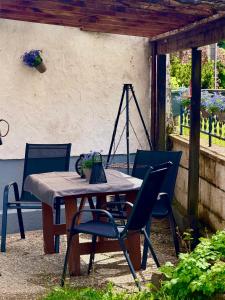 a table and chairs sitting on a patio at EifelFein in Niederstadtfeld