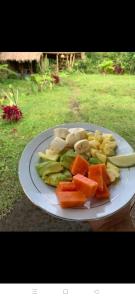 a plate of fruit and vegetables on a table at Rinjani inn Lombok in Tetebatu