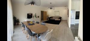 a dining room and living room with a table and chairs at Atlantic Foz in Buarcos +11 photos