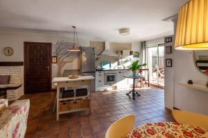 a kitchen and living room with a table and a counter at Uribe-Biscay in Menaka +48 photos
