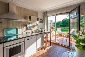 a kitchen with a sink and a large window at Uribe-Biscay in Menaka