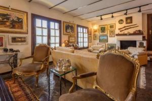 a living room with a couch and chairs and a fireplace at Villa El Jagüel in Sauzal