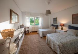 a hotel room with two beds and a bathroom at Uribe-Biscay in Menaka