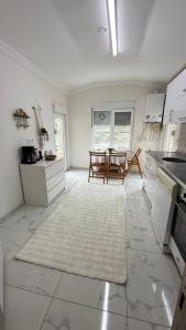 a kitchen with white cabinets and a table in it at Peribacası Manzaralı Modern Daire in Ürgüp +15 photos