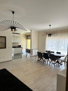a dining room and living room with a table and chairs at Atlantic Foz in Buarcos