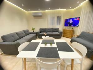 a living room with a table and a couch at Apartment Jorgo Kalithea in Kallithea Halkidikis