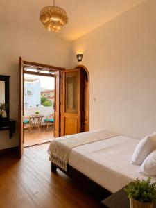 a bedroom with a bed and a balcony with a table at Modern Villa in Dahab in Dahab