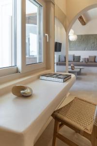 a living room with a white counter and a window at Pnoé Lounge Suite in Mandrakia