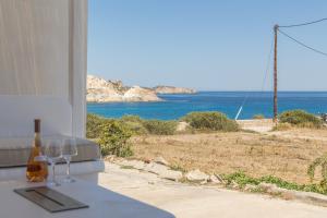 a view of the ocean from a house with wine glasses at Pnoé Lounge Suite in Mandrakia