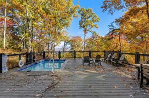 a swimming pool with benches next to a fence at Soakin Up The Views in Gatlinburg