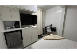 a bedroom with a bed and a flat screen tv at Habitación Tulipán in Oaxaca City