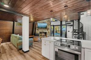 a kitchen with a stove and a living room at Soakin Up The Views in Gatlinburg
