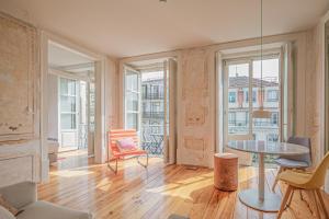a living room with a table and chairs at Antiga Casa Pessoa in Lisbon