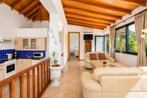a living room with couches and a kitchen at Villa Driftwood in Rhodes Town