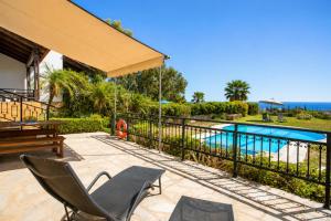 a patio with a fence and a swimming pool at Villa Driftwood in Rhodes Town +12 photos