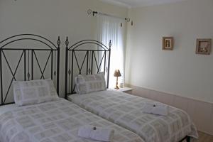 a bedroom with two beds with towels on them at Ons Kraal in Franskraal