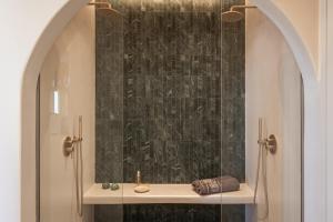 a bathroom with a sink and a shower at Pnoé Lounge Suite in Mandrakia +39 photos