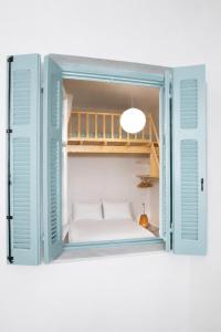 a room with a window with a bed in it at Mirtilo - Local Style, 1 Min from Main Beach in Kardamaina
