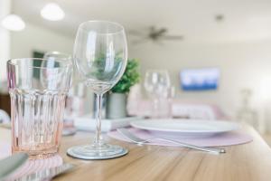 a table with two wine glasses and a plate on it at 102 Cecil Cir 3BR2 House in Calera