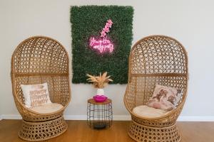 two wicker chairs sitting in a room with a wall at 102 Cecil Cir 3BR2 House in Calera +20 photos