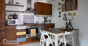 a kitchen with a table and chairs and a microwave at Ca' Rossa Lido Venezia in Mestre