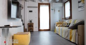 a living room with a couch and a window at Ca' Rossa Lido Venezia in Mestre