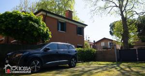 a black car parked in front of a house at Ca' Rossa Lido Venezia in Mestre