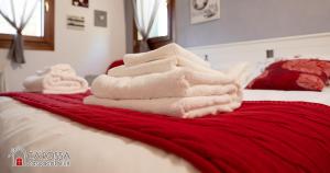 a pile of towels sitting on top of a bed at Ca' Rossa Lido Venezia in Mestre +3 photos
