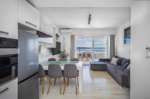 a kitchen and living room with a table and chairs at Villa Collis in Makarska