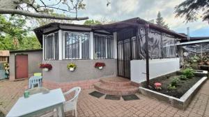 a small house with a gazebo and a brick patio at Таки Дача на Фонтане in Odesa